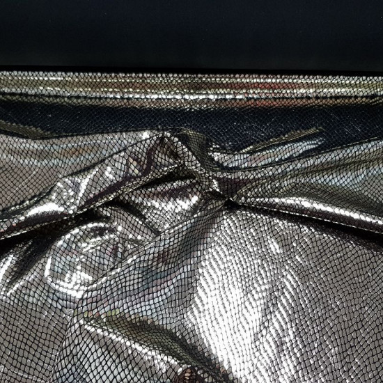 Lycra Silver Snake fabric - Elastic lycra fabric with drawing imitating snake skin in bright silver on a black background. The fabric is 150cm wide and its composition 92% polyester - 8% spandex