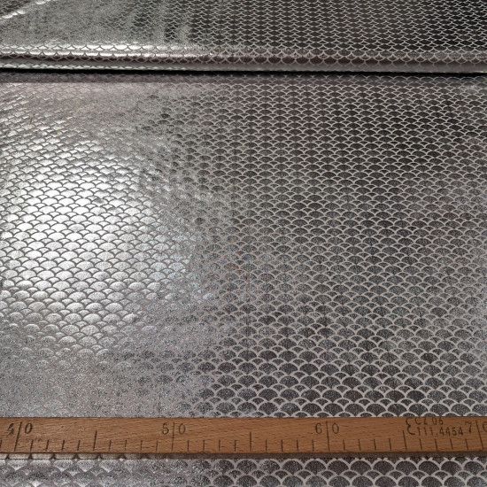 Lycra Mermaid Scales fabric - Fine stretch lycra fabric with drawings of bright mermaid scales in white/silver colors. The fabric is 150cm wide and its composition 97% polyester - 3% spandex