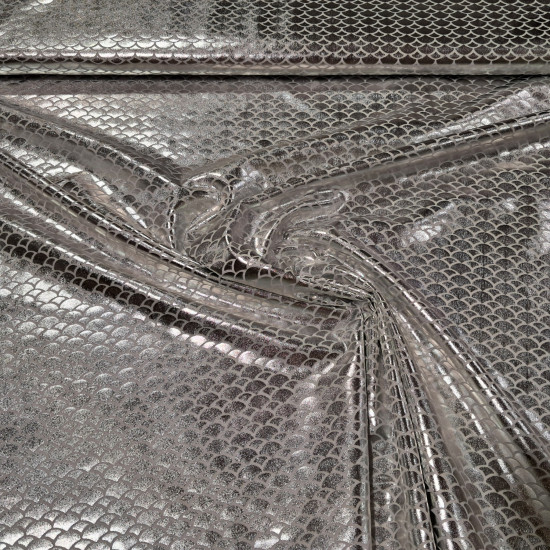 Lycra Mermaid Scales fabric - Fine stretch lycra fabric with drawings of bright mermaid scales in white/silver colors. The fabric is 150cm wide and its composition 97% polyester - 3% spandex