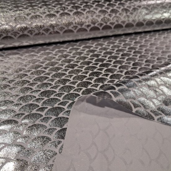 Lycra Mermaid Scales fabric - Fine stretch lycra fabric with drawings of bright mermaid scales in white/silver colors. The fabric is 150cm wide and its composition 97% polyester - 3% spandex