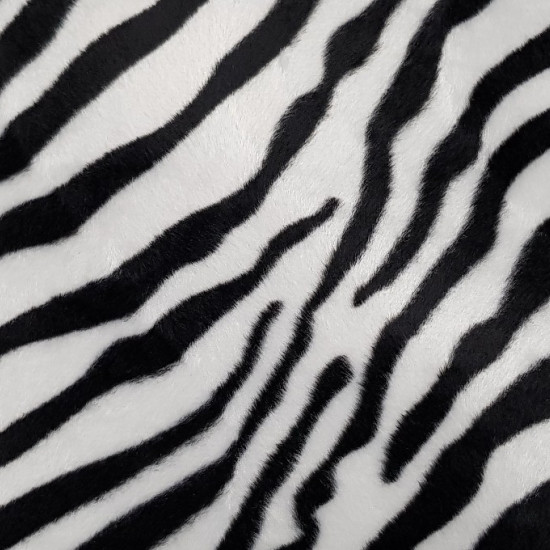 Velboa Zebra Print fabric - Velboa hair fabric, short and soft, with black stripes on a white background imitating the skin of a zebra. The fabric is 150cm wide and its composition 100% polyester.