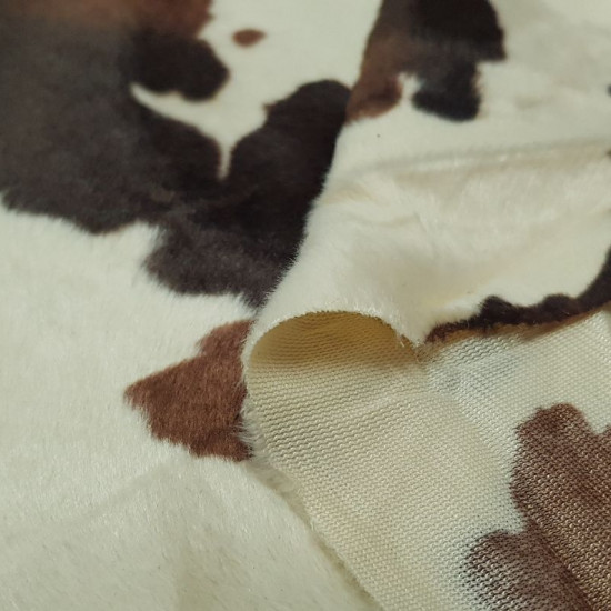 Velboa Colt Print fabric - Velboa short hair fabric, with a pattern of black and brown spots imitating the skin of a colt. The fabric is 150cm wide and its 100% polyester composition.