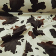 Velboa Colt Print fabric - Velboa short hair fabric, with a pattern of black and brown spots imitating the skin of a colt. The fabric is 150cm wide and its 100% polyester composition.