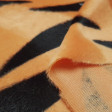 Velboa Tiger Print fabric - Velboa soft short hair fabric, with black stripe pattern on an orange background, imitating the skin of a tiger. The fabric is 150cm wide and its 100% polyester composition.