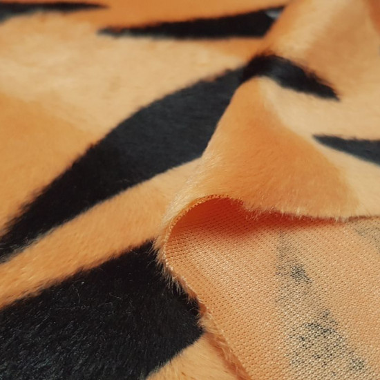 Velboa Tiger Print fabric - Velboa soft short hair fabric, with black stripe pattern on an orange background, imitating the skin of a tiger. The fabric is 150cm wide and its 100% polyester composition.