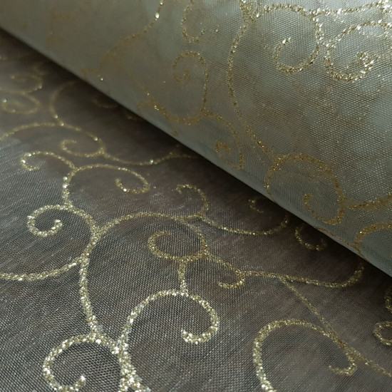 Organza Golden Tangled fabric - Semi-transparent organza fabric in gold color with tangles and shiny shapes in gold color. The fabric is 150cm wide and its composition 100% polyester