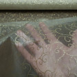 Organza Golden Tangled fabric - Semi-transparent organza fabric in gold color with tangles and shiny shapes in gold color. The fabric is 150cm wide and its composition 100% polyester