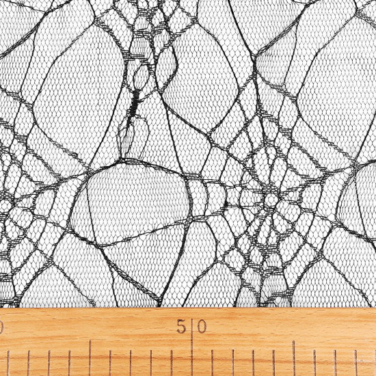Tulle Halloween Cobwebs fabric - Fine and soft black tulle fabric with cobwebs pattern, ideal for halloween themed decorations, costumes, veils, skirts ... The fabric is 160cm wide and its composition is 100% polyester.