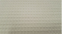 Waffle Cotton fabric - Waffle cotton fabric. The waffle or waffle piqué fabric is characterized by its embossed squares making the shape of a waffle or honeycomb. It is widely used in children's clothing and home. We offer you a waffl