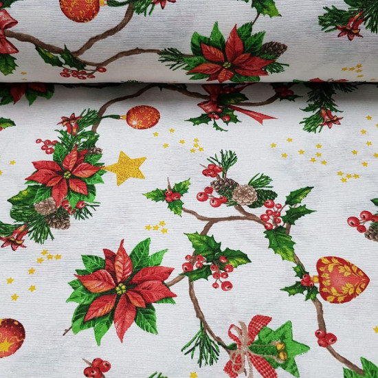 Canvas Christmas Branches Holly fabric - Decorative canvas fabric with drawings of holly branches and ornaments such as jingle bells, bells, balls and hearts on a white background with golden stars. The fabric is 280cm wide and its composition 70% cotton 