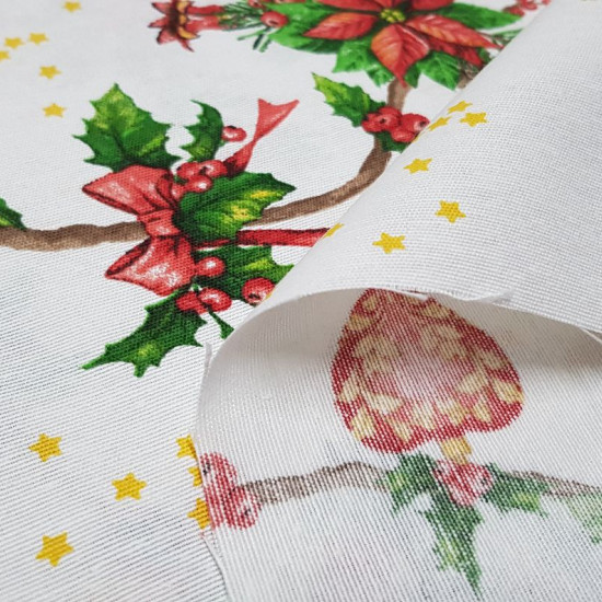 Canvas Christmas Branches Holly fabric - Decorative canvas fabric with drawings of holly branches and ornaments such as jingle bells, bells, balls and hearts on a white background with golden stars. The fabric is 280cm wide and its composition 70% cotton 