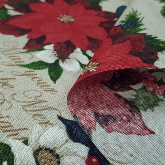 Canvas Christmas Poinsettia fabric - Decorative Christmas-themed canvas fabric where drawings of the Christmas flower, also called poinsettia, appear on a light background with golden letters. The fabric is 280cm wide and its composition is 70% cotton -