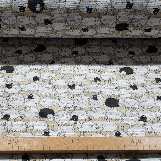Canvas Black Sheep fabric - Fun decorative canvas fabric with pictures of herds of white sheep and some black sheep. The fabric is 280cm wide and its composition is 50% cotton - 50% polyester.
