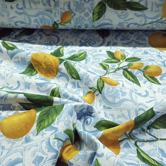 Canvas Lemons Tiles fabric - Decorative canvas fabric with drawings of lemons on a background of hydraulic style tiles in blue tones. The fabric is 280cm wide and its composition is 70% cotton - 30% polyester.