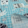 Canvas Cats Grids Blue fabric - Decorative canvas fabric with cat drawings on a turquoise blue grid background. The fabric is 280cm wide and its composition is 70% cotton - 30% polyester.