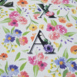 Half Panama Digital Flowers Letters fabric - Half Panama canvas fabric in digital print with colorful flower drawings and large letters on a white background. The fabric is 280cm wide and its composition 100% cotton.