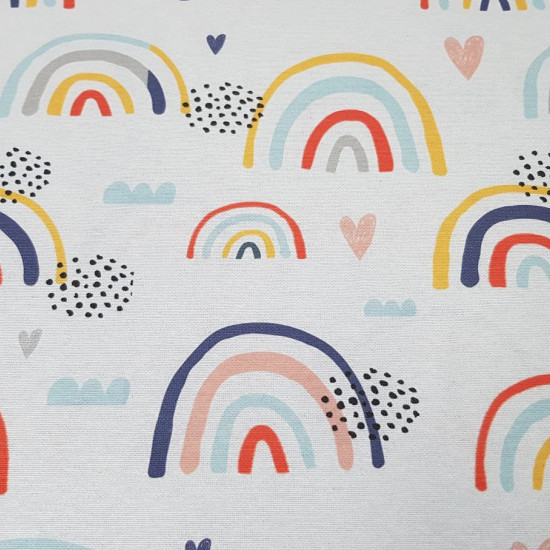 Half Panama Rainbow Colors fabric - Decorative fabric half panama with drawings of colored rainbows, clouds and hearts on a white background. The half panama fabric is widely used in home decoration, as well as some garments. The fabric is 280cm wide a