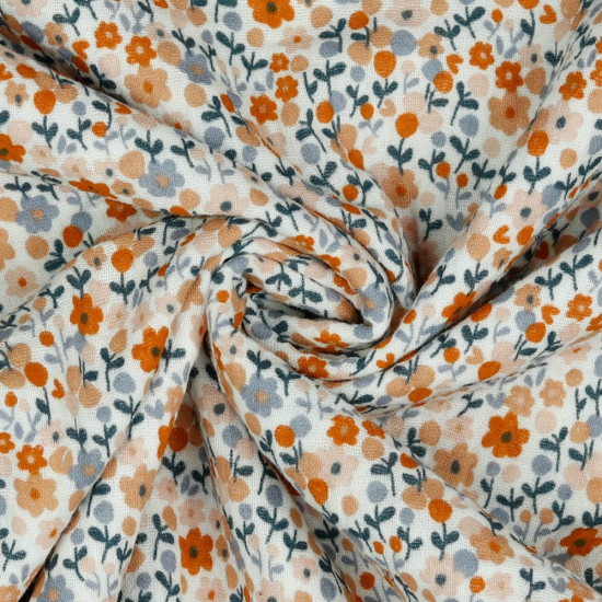 Double Gauze Little Flowers fabric - Organic cotton double gauze fabric with flower drawings in various colors. A soft and light fabric ideal for children's clothing and dresses. The fabric is 135cm wide and its composition is 100% cotton.
