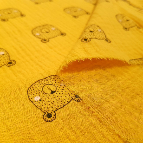 Double Gauze Bear Face fabric - Double gauze fabric made of organic cotton with drawings of bear faces on a mustard background. This light fabric can be used to make beautiful clothes for babies and children, such as harem pants for your baby. The