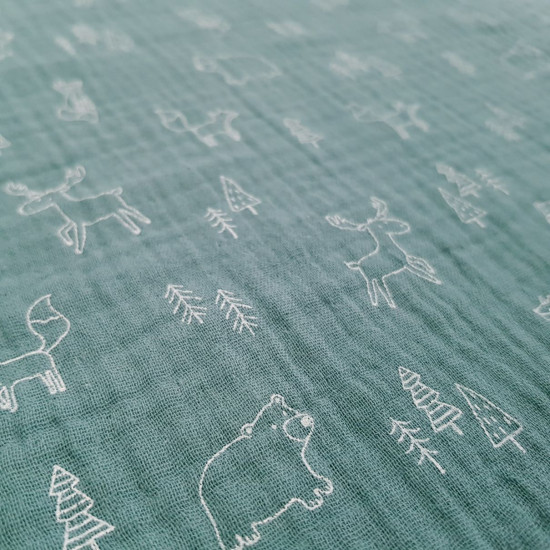 Double Gauze Forest Animals fabric - Organic cotton double gauze fabric with drawings in white lines of trees and forest animals (deer, bears and foxes) on an old green background. The fabric measures 135cm wide and its composition is 100% cotton.