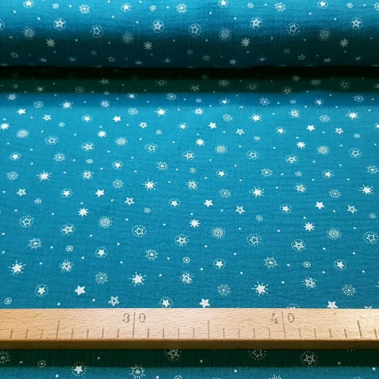 Double Gauze Space Stars fabric - Double gauze cotton fabric with drawings of various types of stars that remind us of space, on a colored background. The fabric measures 135cm wide and its composition is 100% cotton.