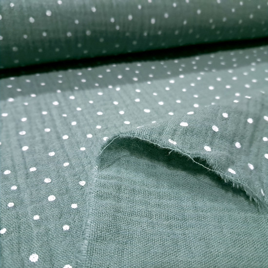 Detalle de tela doble gasa rosa y verde con estampado de puntos blancos