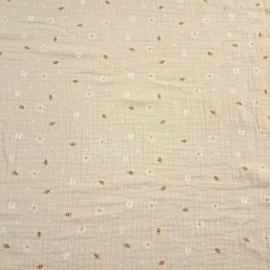 Double Gauze Bees Flowers fabric - Very lightweight double gauze cotton fabric with bee and flower designs on a beige background. The fabric is 135cm wide and 100% cotton.