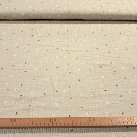 Double Gauze Bees Flowers fabric - Very lightweight double gauze cotton fabric with bee and flower designs on a beige background. The fabric is 135cm wide and 100% cotton.
