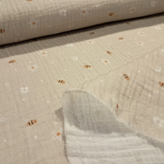Double Gauze Bees Flowers fabric - Very lightweight double gauze cotton fabric with bee and flower designs on a beige background. The fabric is 135cm wide and 100% cotton.