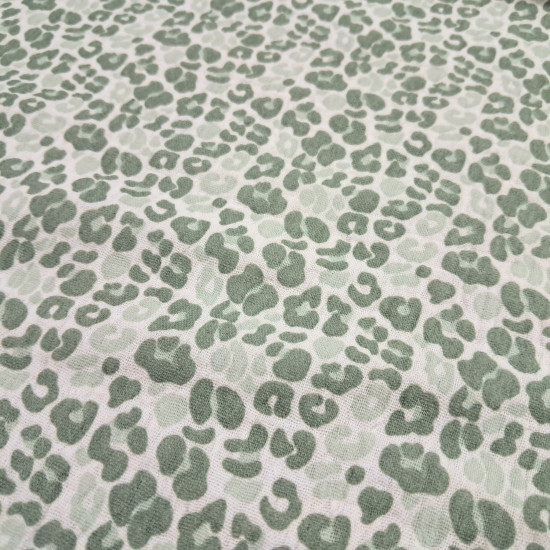 Double Gauze Animal Print fabric - Double gauze or two-layer muslin cotton fabric with green animal print designs on a white background. The fabric is 135cm wide and is made from 100% cotton.
