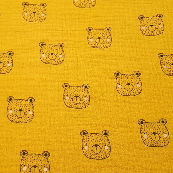 Double Gauze Bear Face fabric - Double gauze fabric made of organic cotton with drawings of bear faces on a mustard background. This light fabric can be used to make beautiful clothes for babies and children, such as harem pants for your baby. The
