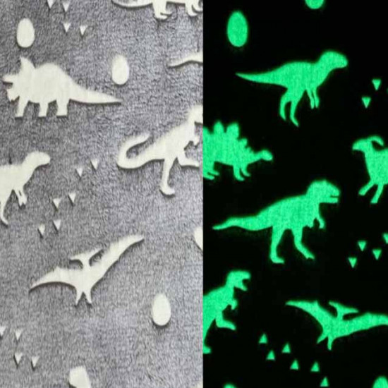 Coral Fleece Neon Dinosaurs fabric - Coral fleece fabric with a very soft touch, with drawings of dinosaurs in relief whose silhouette lights up in the dark. The fabric has to be "charged" with natural or artificial light, before the neon effect