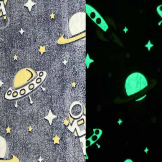 Coral Fleece Neon Spaceships fabric - Coral fleece fabric with a very soft touch, with relief drawings of spaceships, stars, planets and astronauts whose silhouette lights up in the dark. The fabric has to be "charged" with natural or artificial