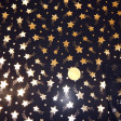Golden Stars fabric - Fine shiny fabric ideal for costumes with drawings of gold stars on a black background. The fabric is 150cm wide and its composition is 100% polyester