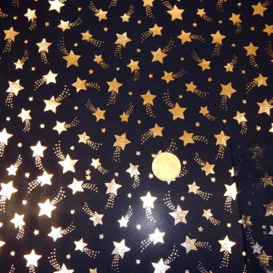 Tela Fondo Negro - Tela fina brillante ideal para disfraces con dibujos de estrellas doradas sobre fondo negro. La tela mide 150cm de ancho y su composición 100% poliester