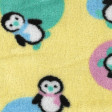 Polar Coralina Pinguïnos fabric - Tejido polar infantil tipo coralina con dibujos de pinguïnos con bufandas de colores sobre fondo amarillo y topos de colores. La tela mide 150cm de ancho y la composición es 100% poliester.