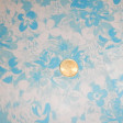 Knit Flowers fabric - Silk Knitted Fabric Printed with drawings of white flowers on a light blue background.